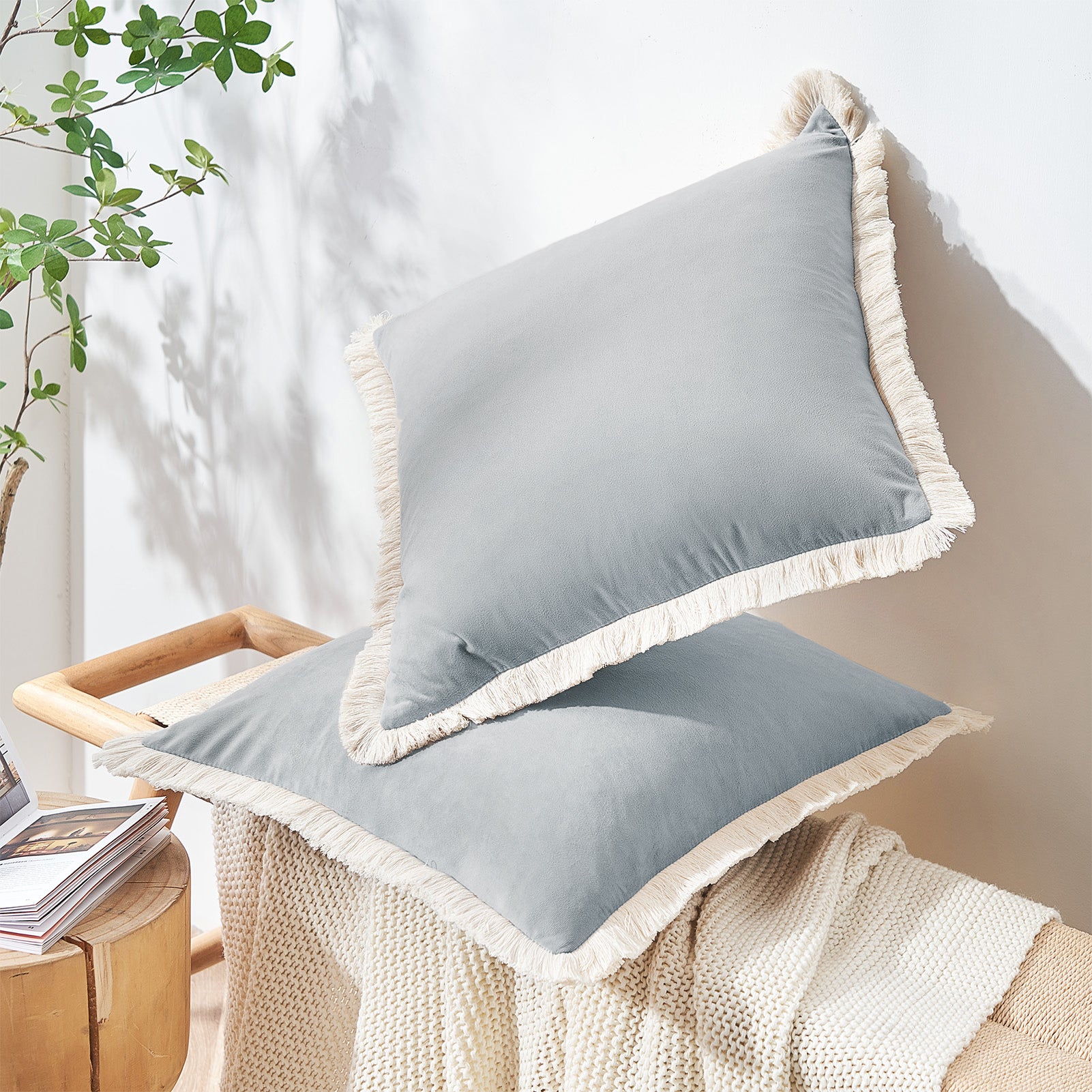 Gray cushions with white trim on a chair in a home setting