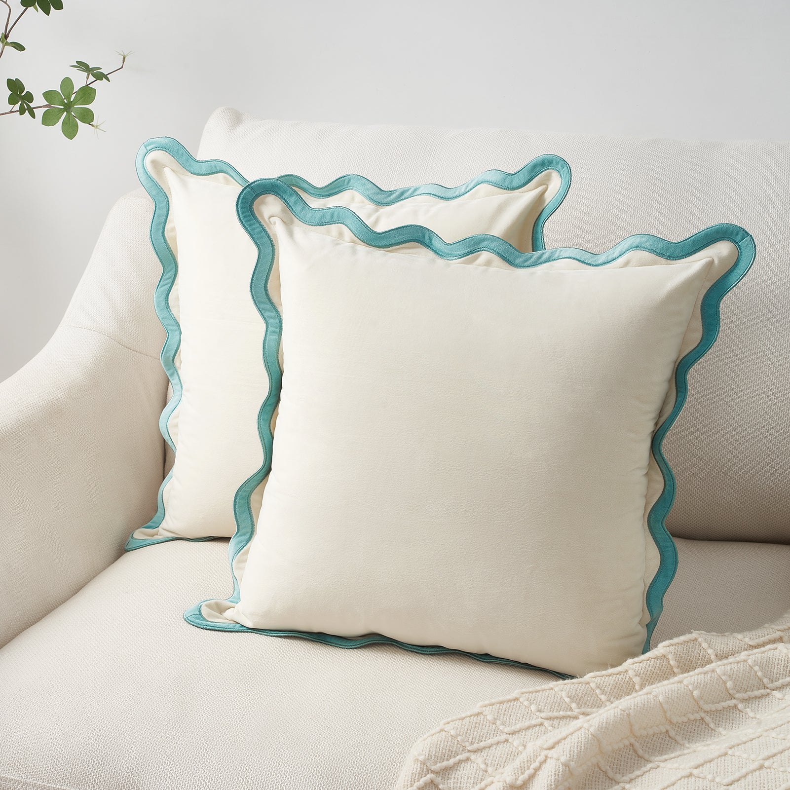 White pillows with blue trim on a neutral background