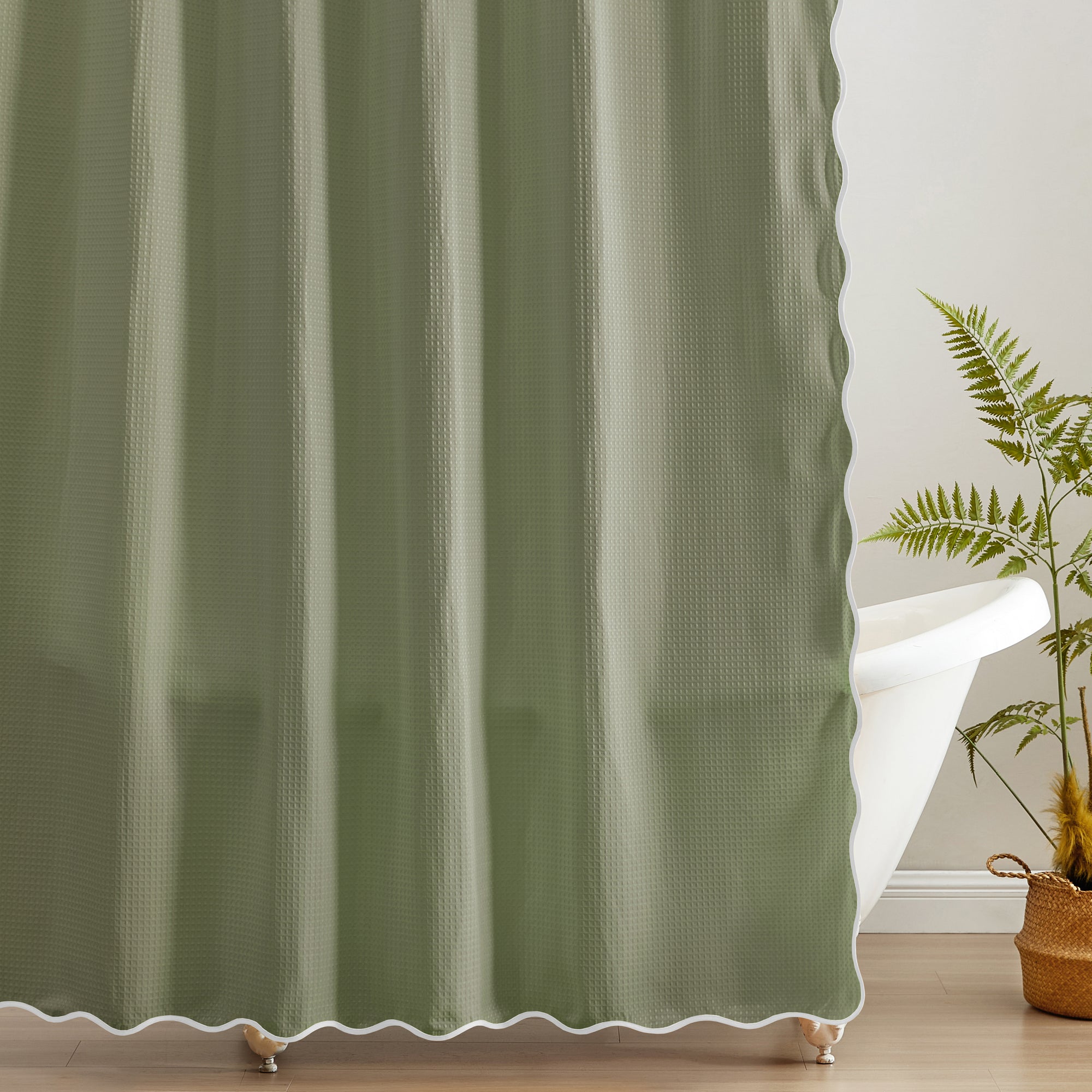 Green curtain with white trim in a room with a plant
