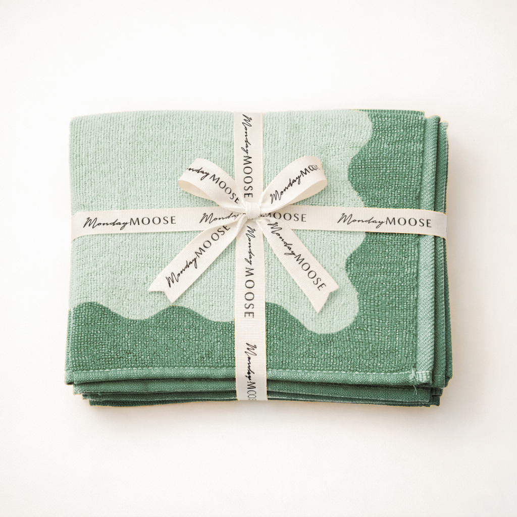 Set of green napkins tied with a white ribbon on a white background