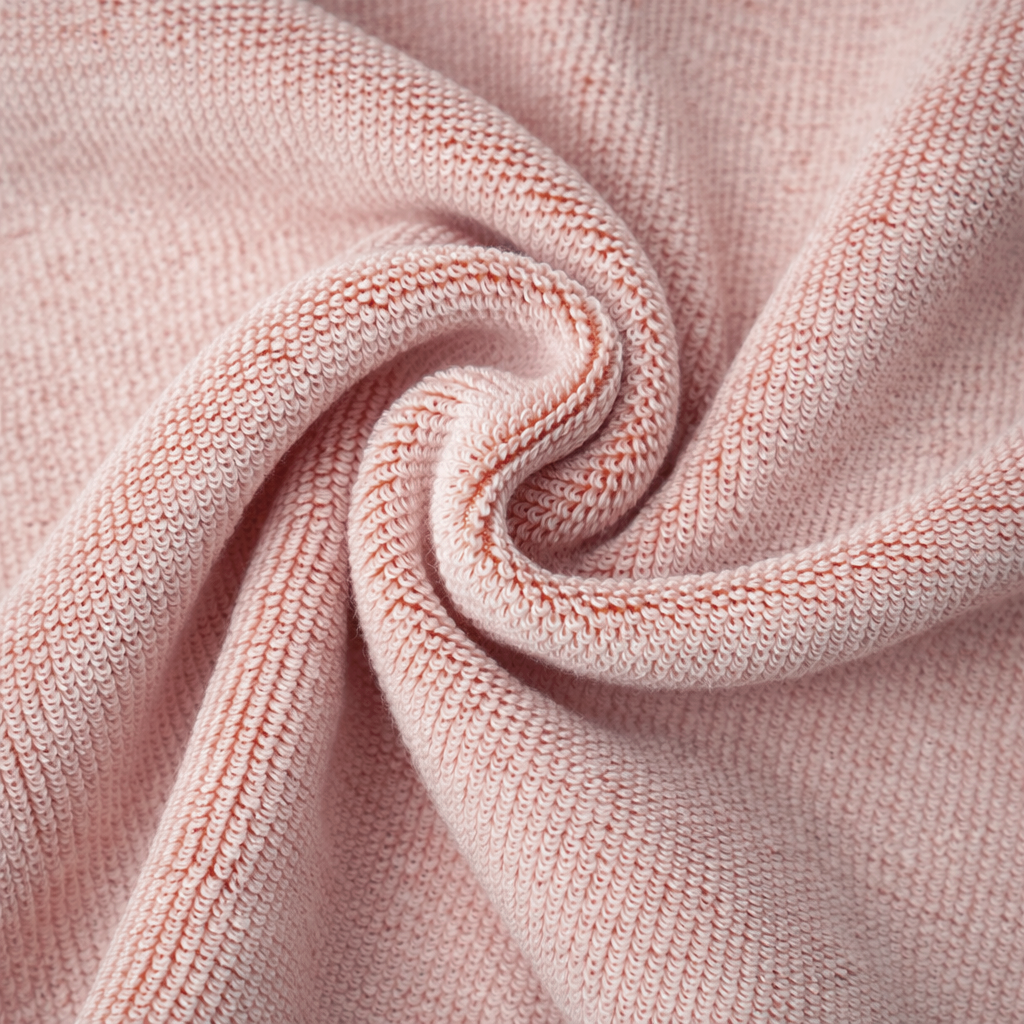 Close-up of pink knitted fabric with a soft texture