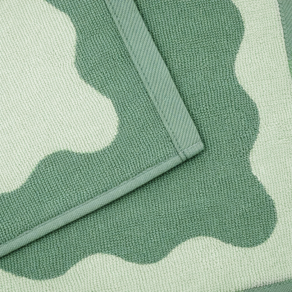 Close-up of a green and white patterned rug