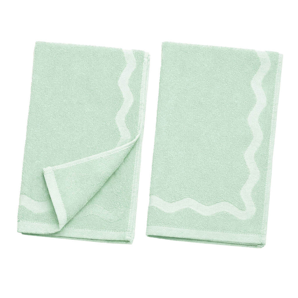 Two light green towels on a white background