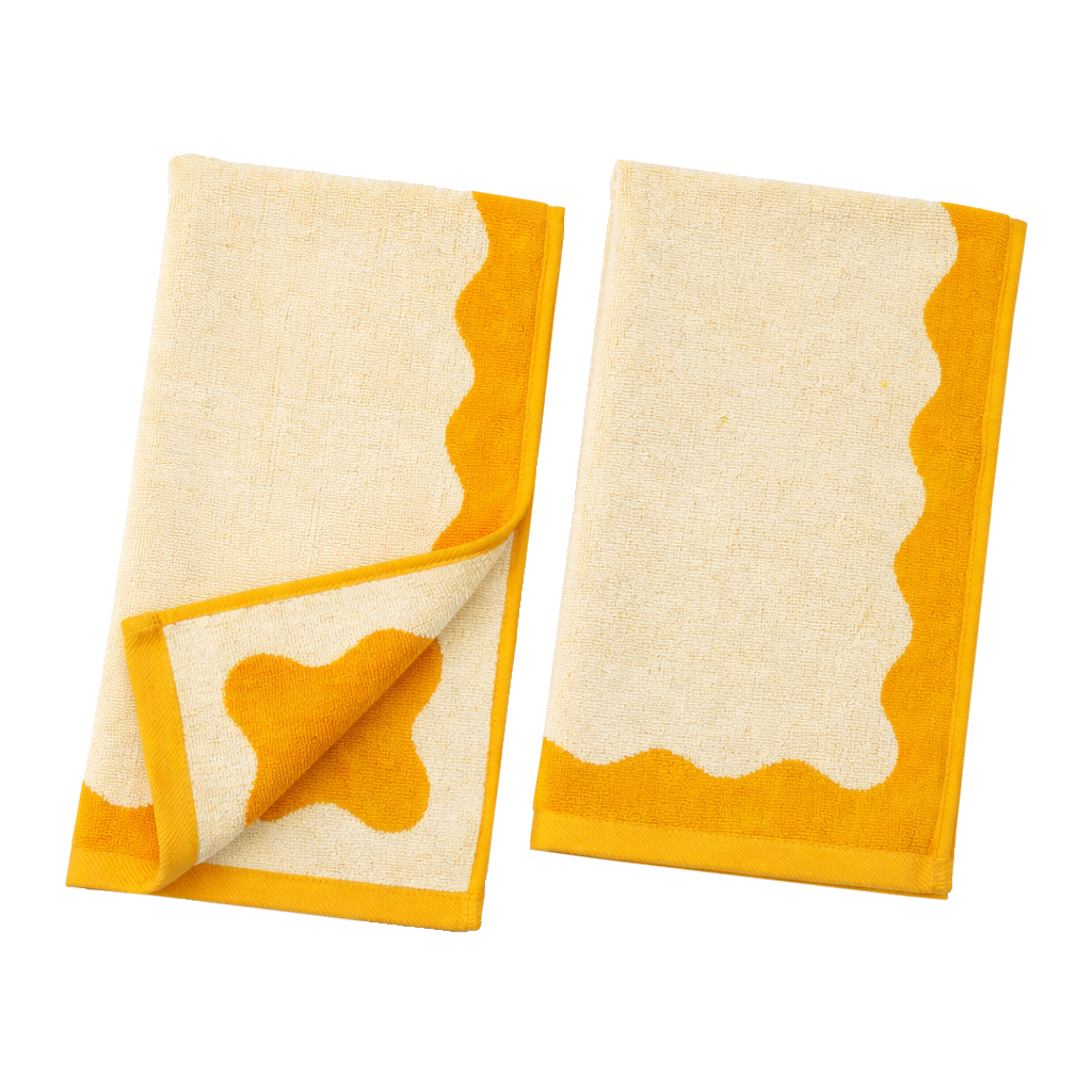 Two cream-colored towels with yellow borders on a white background