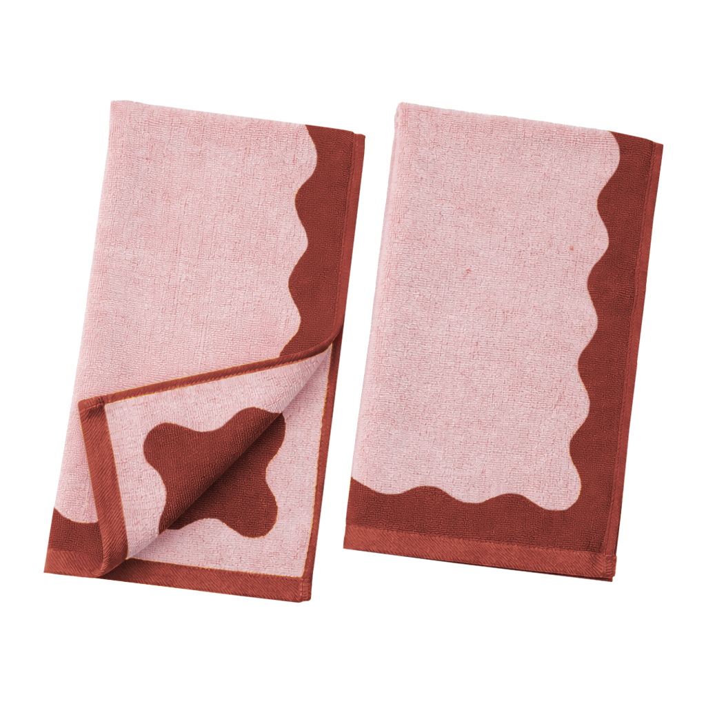 Two pink towels with brown borders on a white background