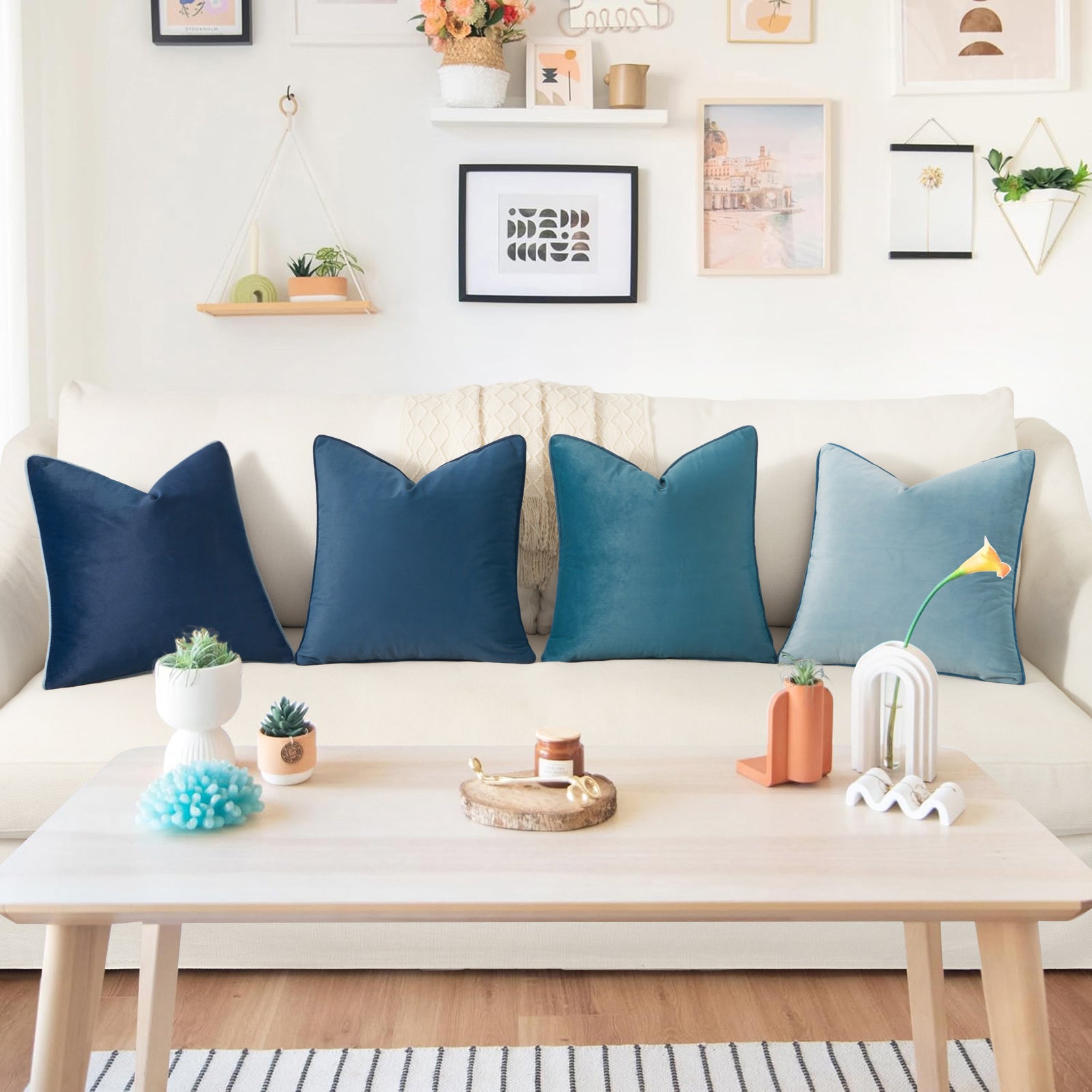 Decorative pillows on a white sofa with a coffee table in a living room setting.