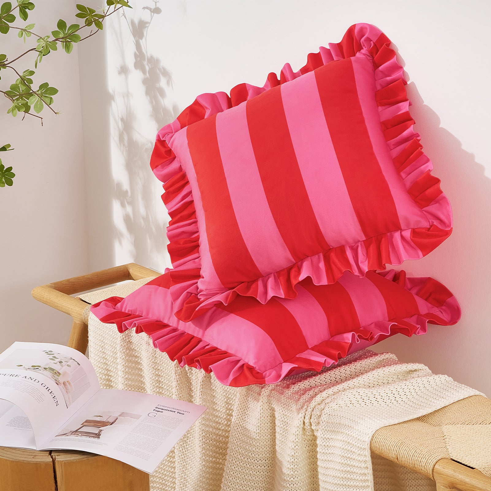 Red and pink striped cushions with ruffles on a wooden chair.