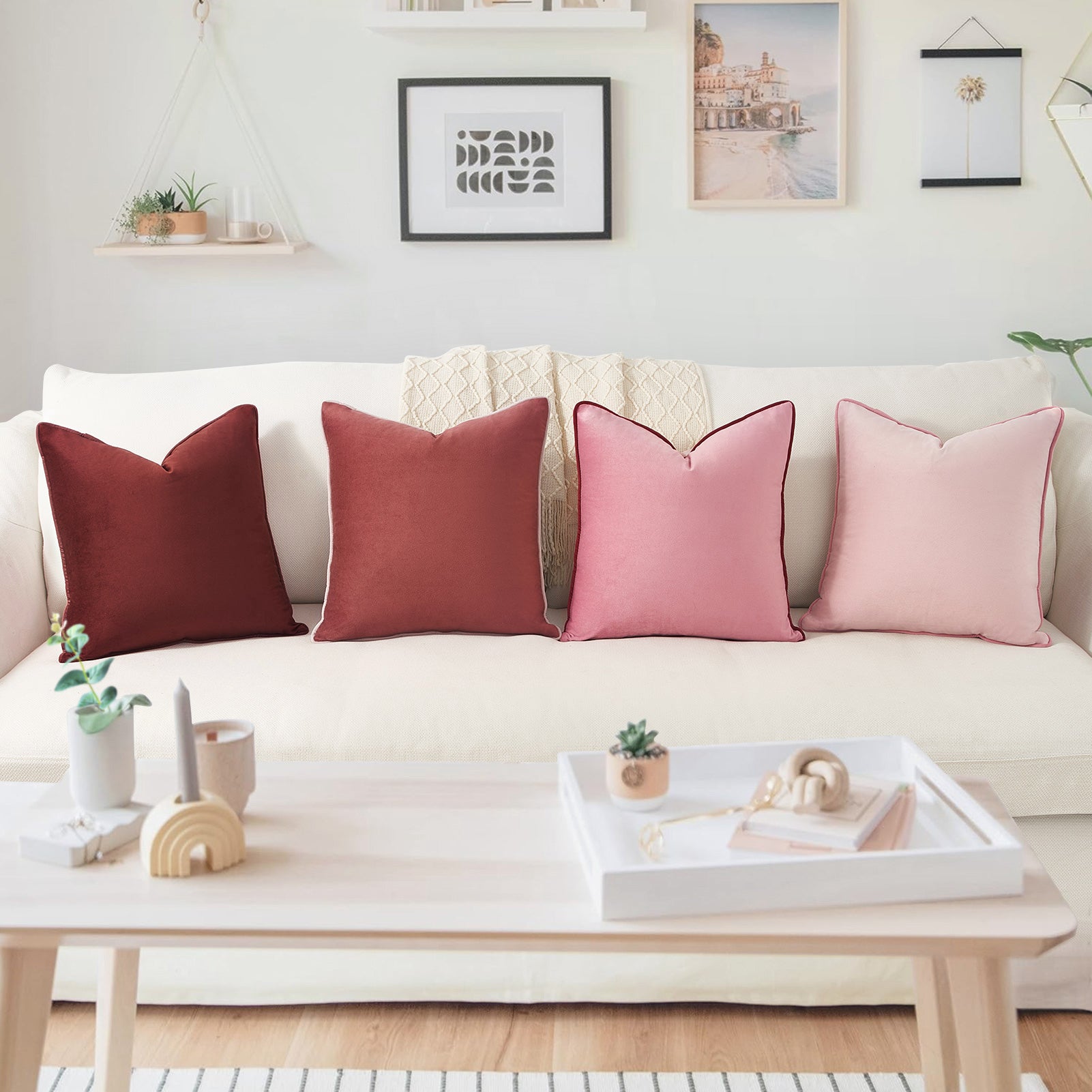 White sofa with red and pink cushions in a living room setting.