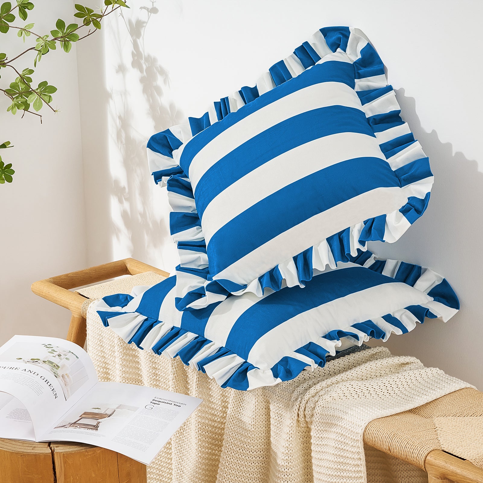 Blue and white striped pillow with ruffles on a wooden chair.