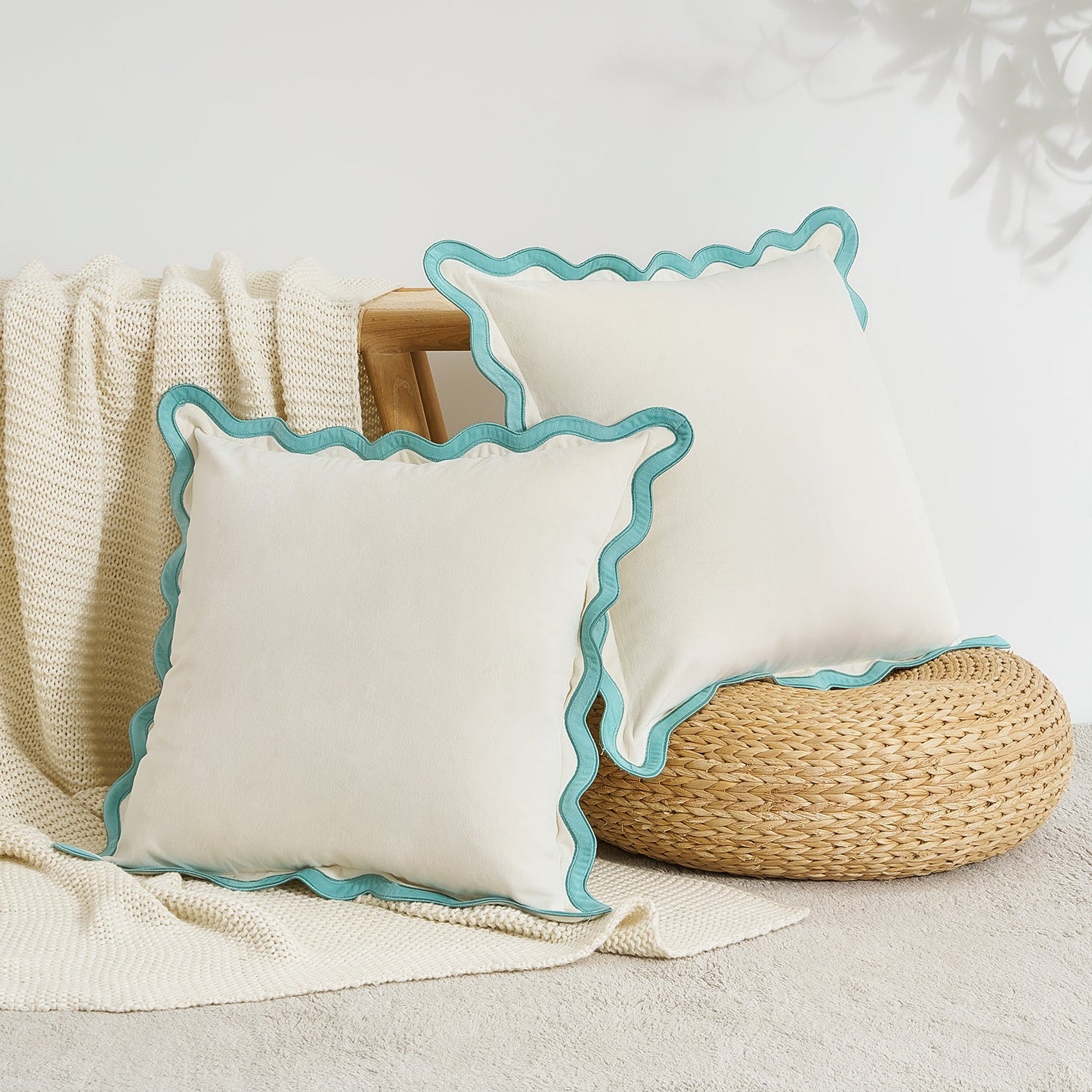 Two white pillows with blue trim on a neutral background