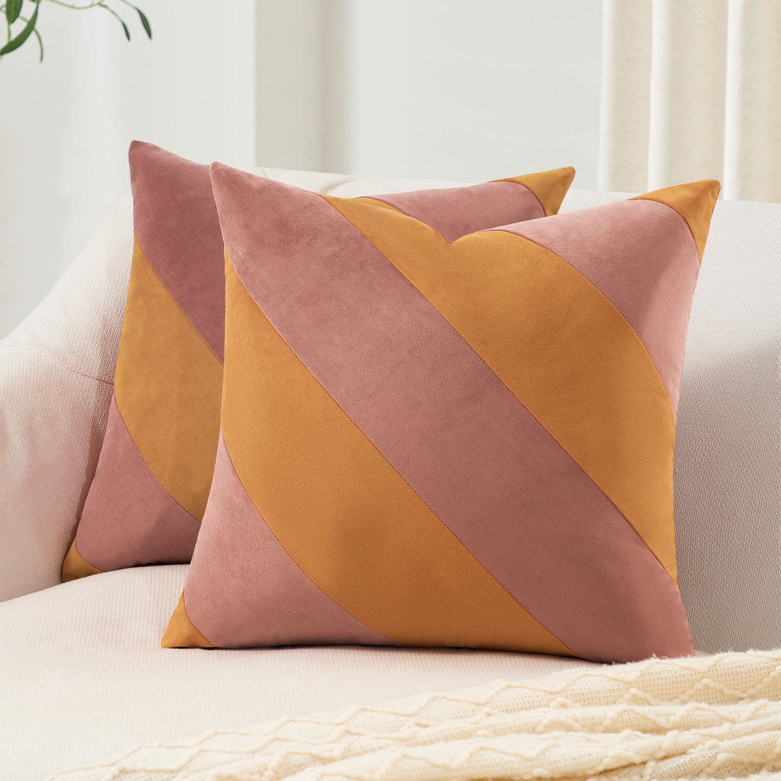 Decorative pillows with a geometric pattern on a sofa.