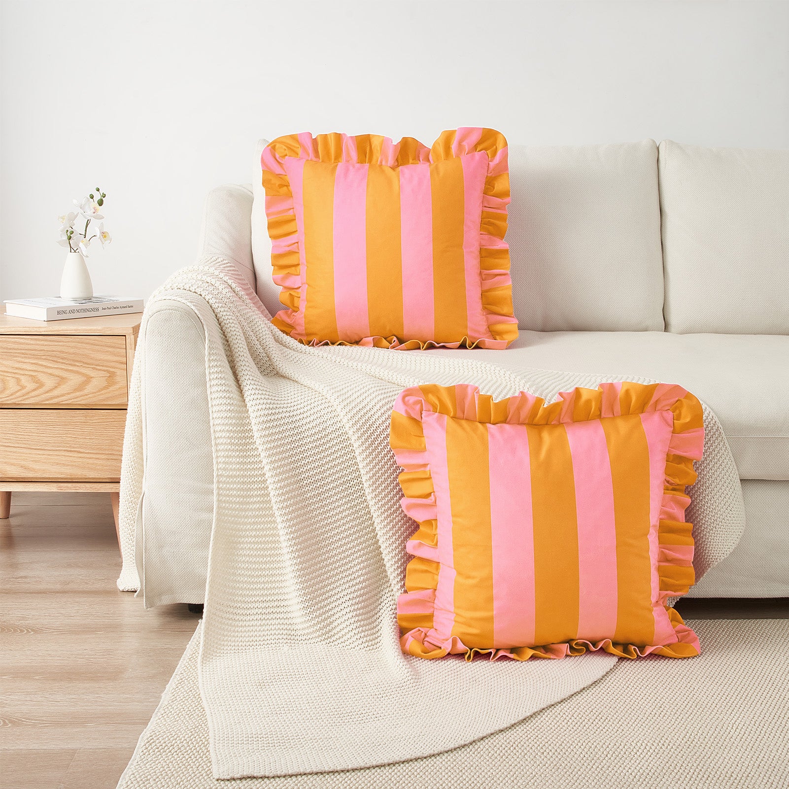 Two striped pillows on a sofa in a living room setting.