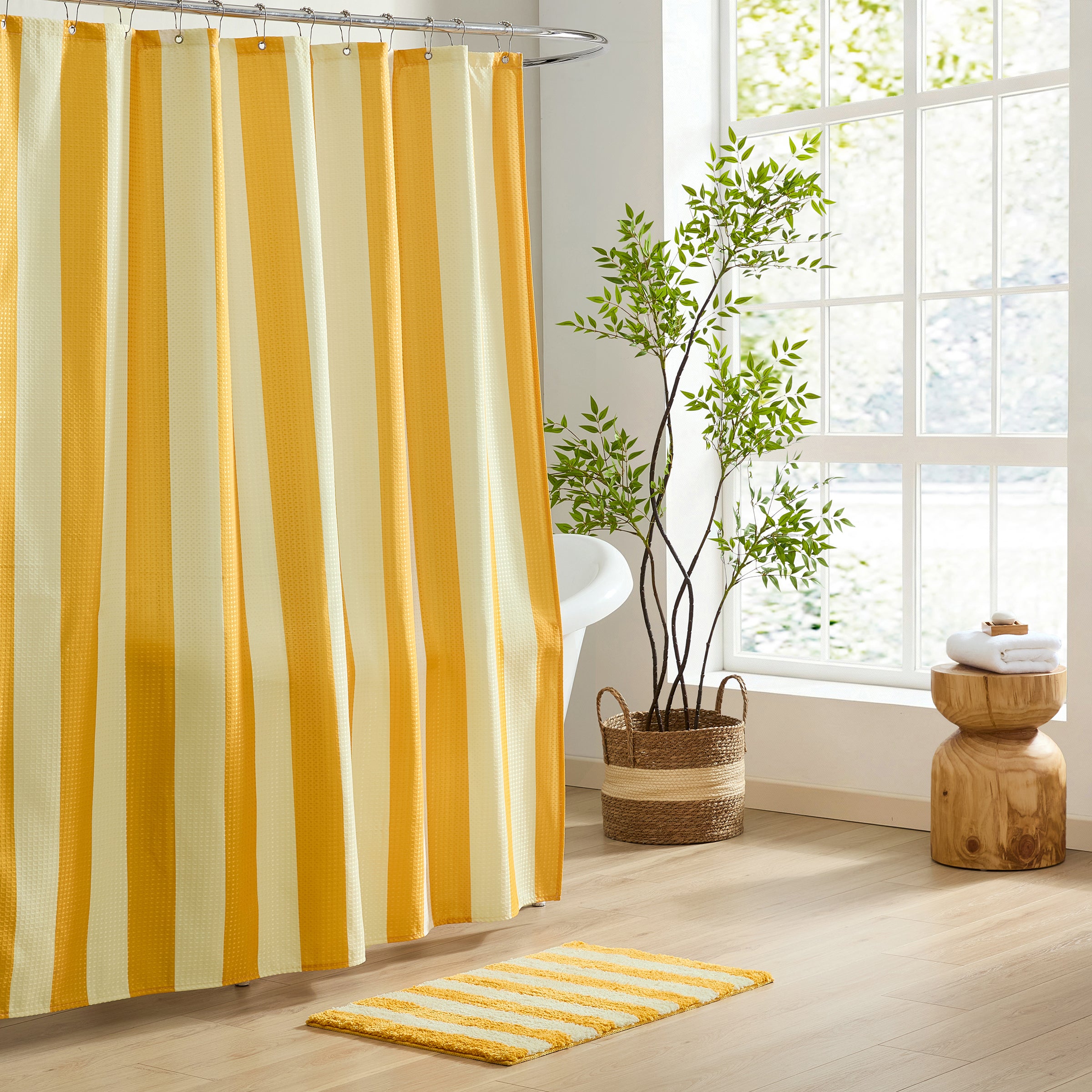 Striped shower curtain with yellow and white stripes in a bathroom setting.