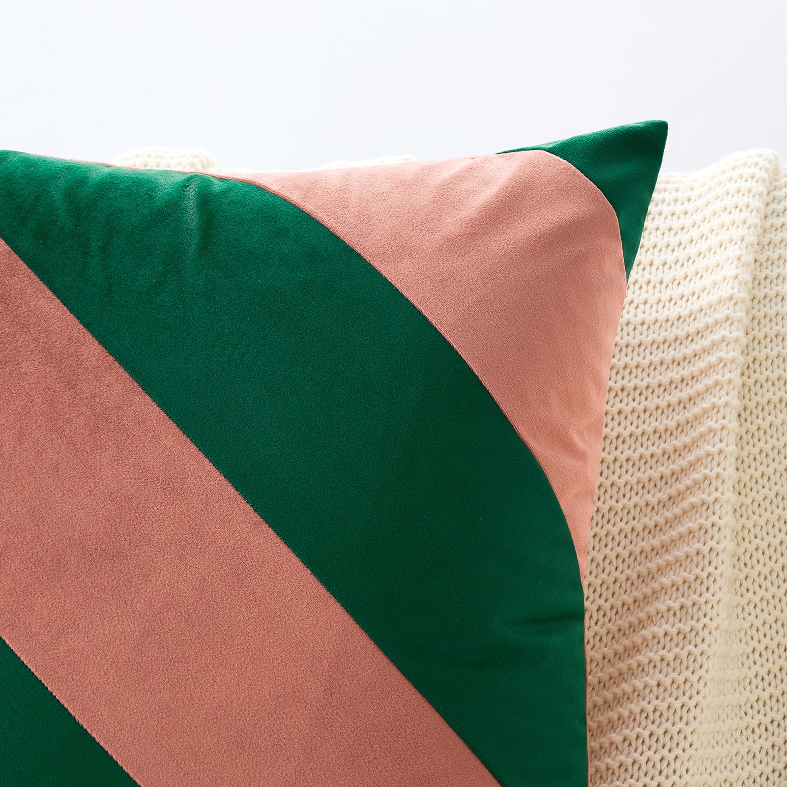Color-blocked pillow with green and pink on a textured surface