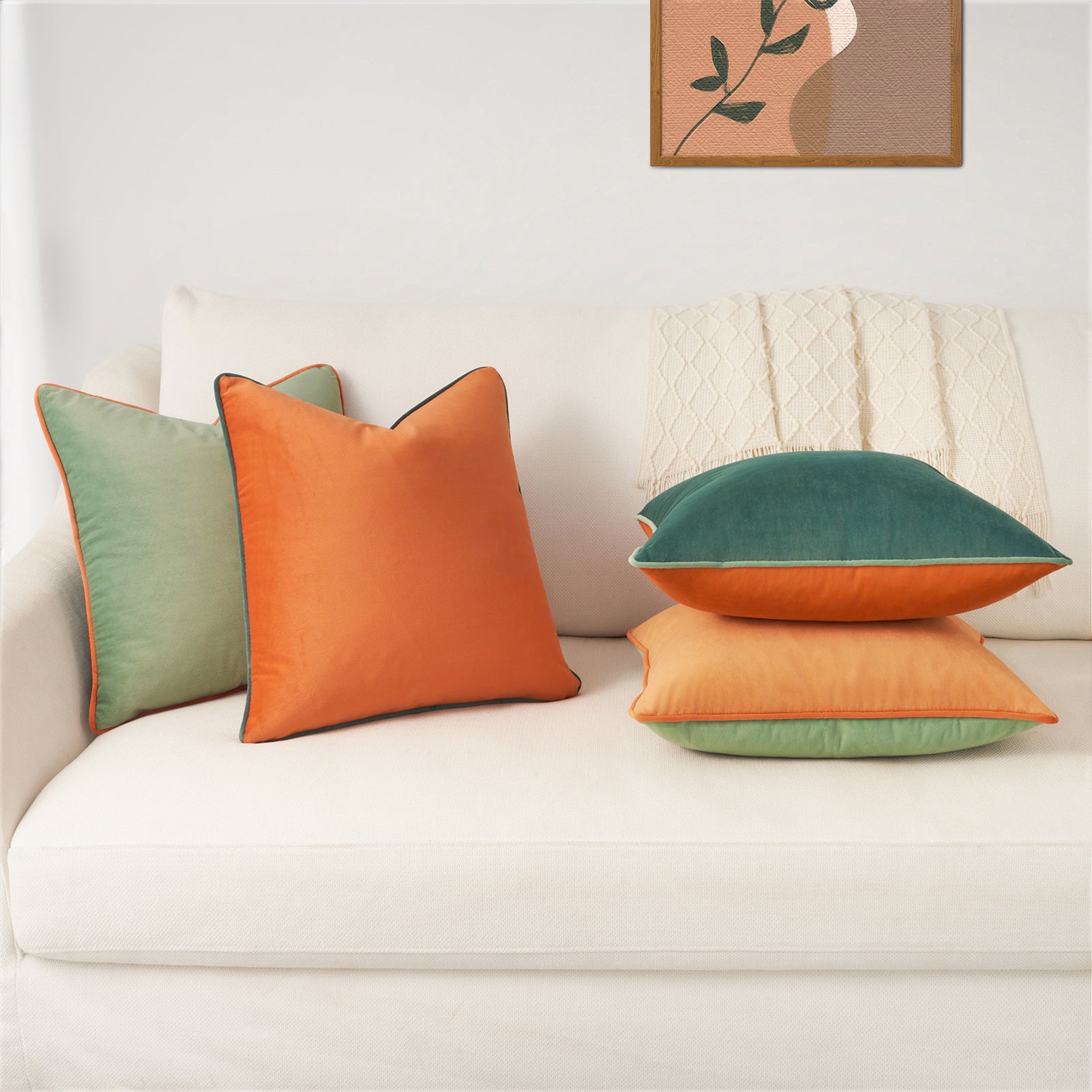 Colorful pillows on a white sofa with a framed picture in the background
