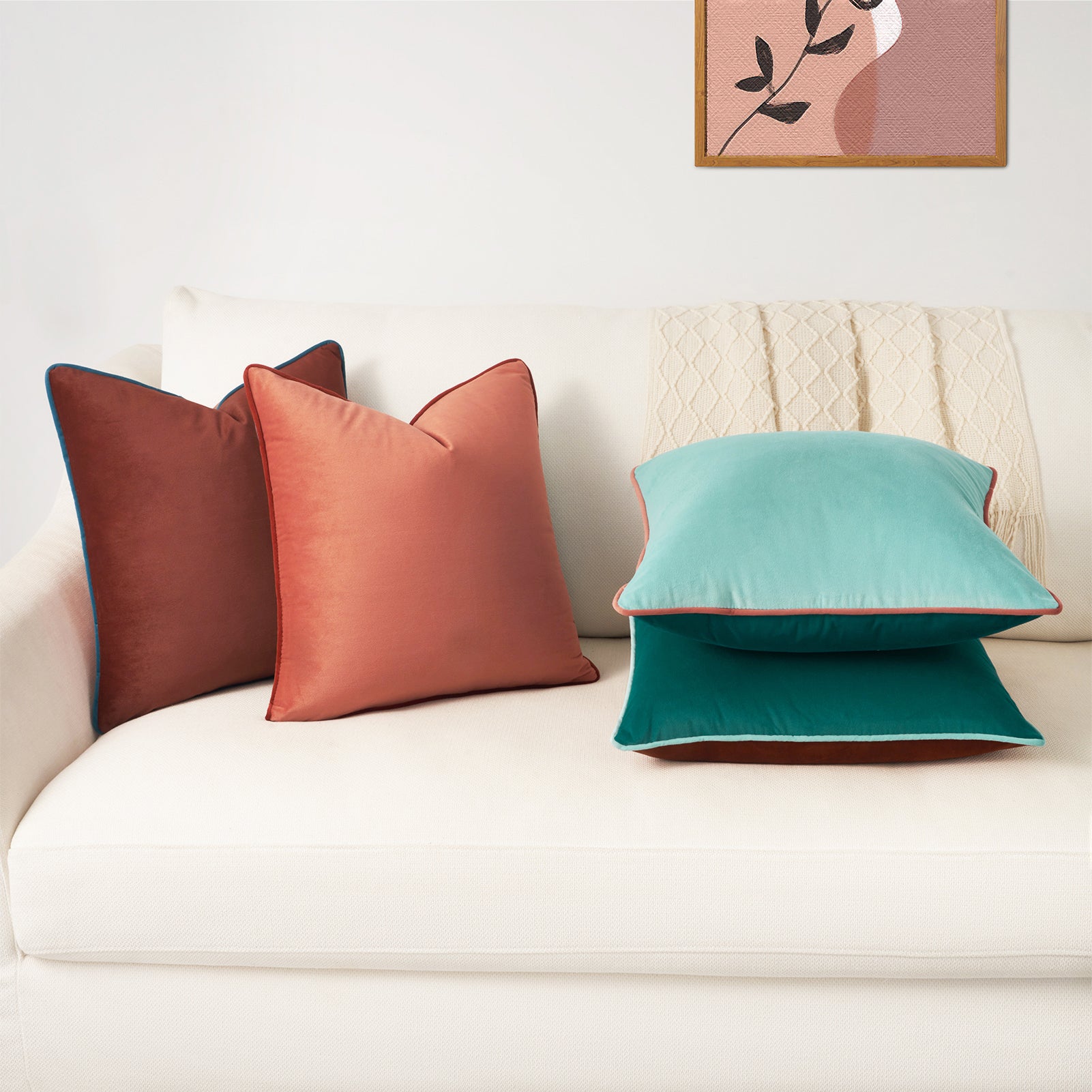 Colorful pillows on a sofa with a decorative painting in the background