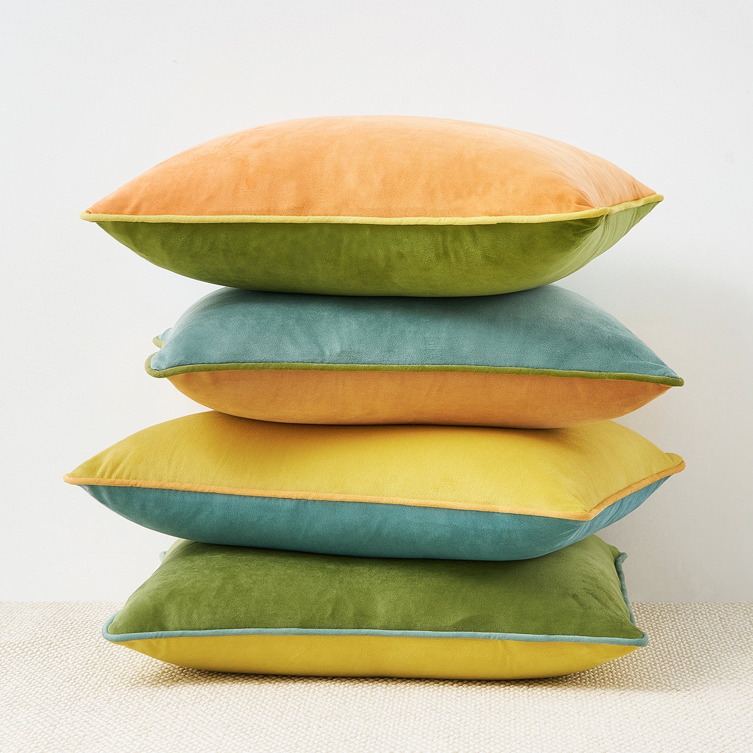 Stack of colorful pillows on a neutral background