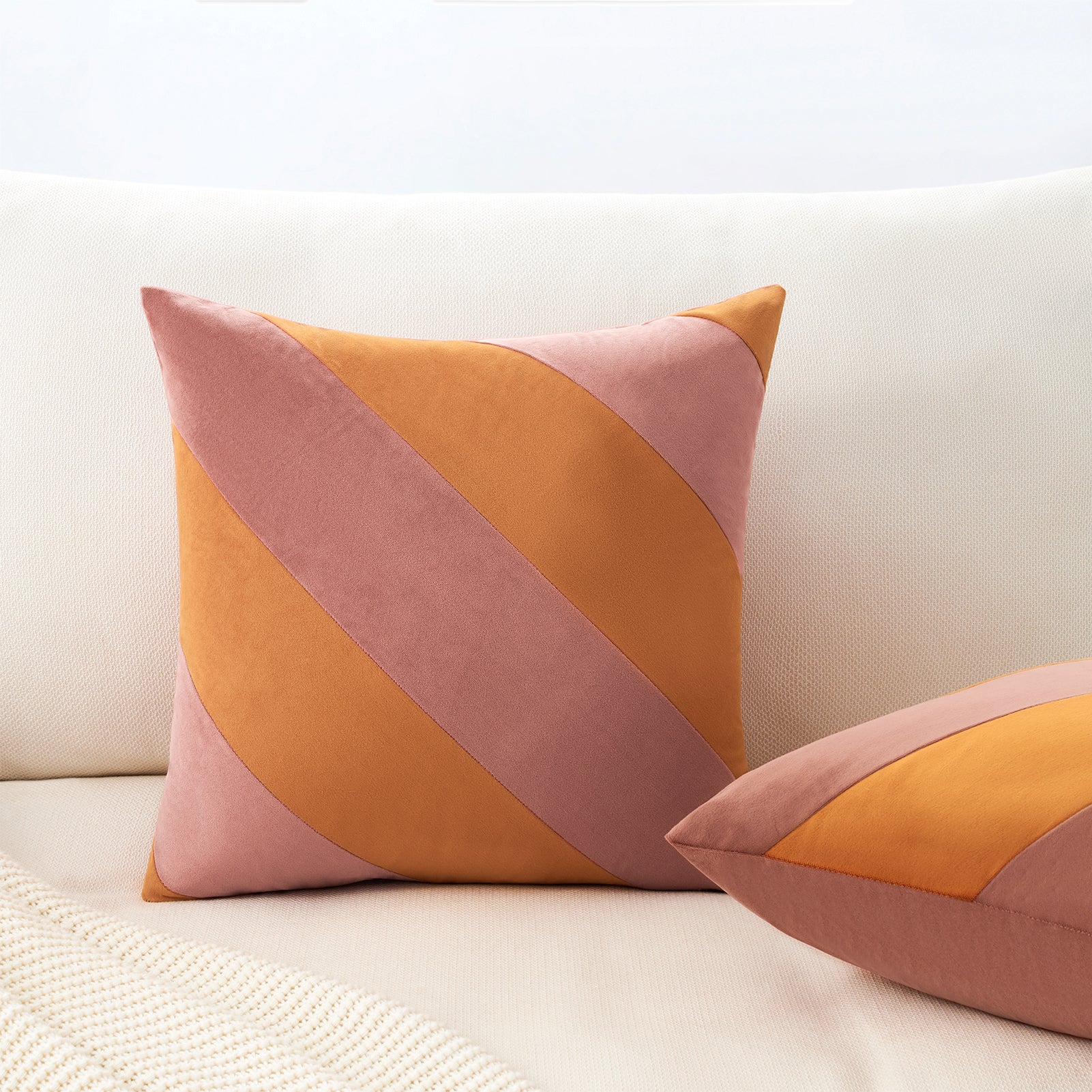 Colorful geometric-patterned pillows on a white couch