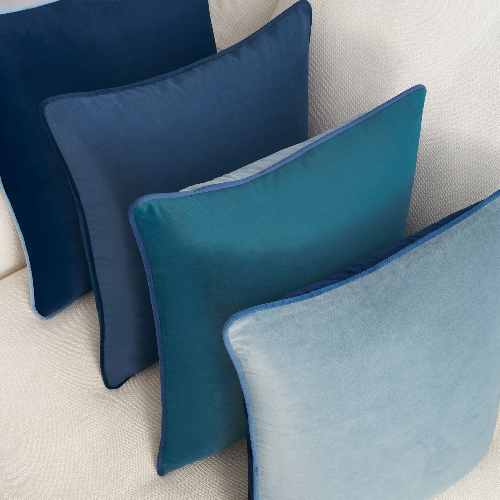 Set of blue pillows on a beige sofa