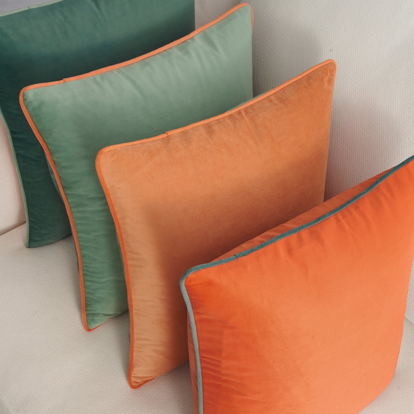 Orange and green cushions on a sofa