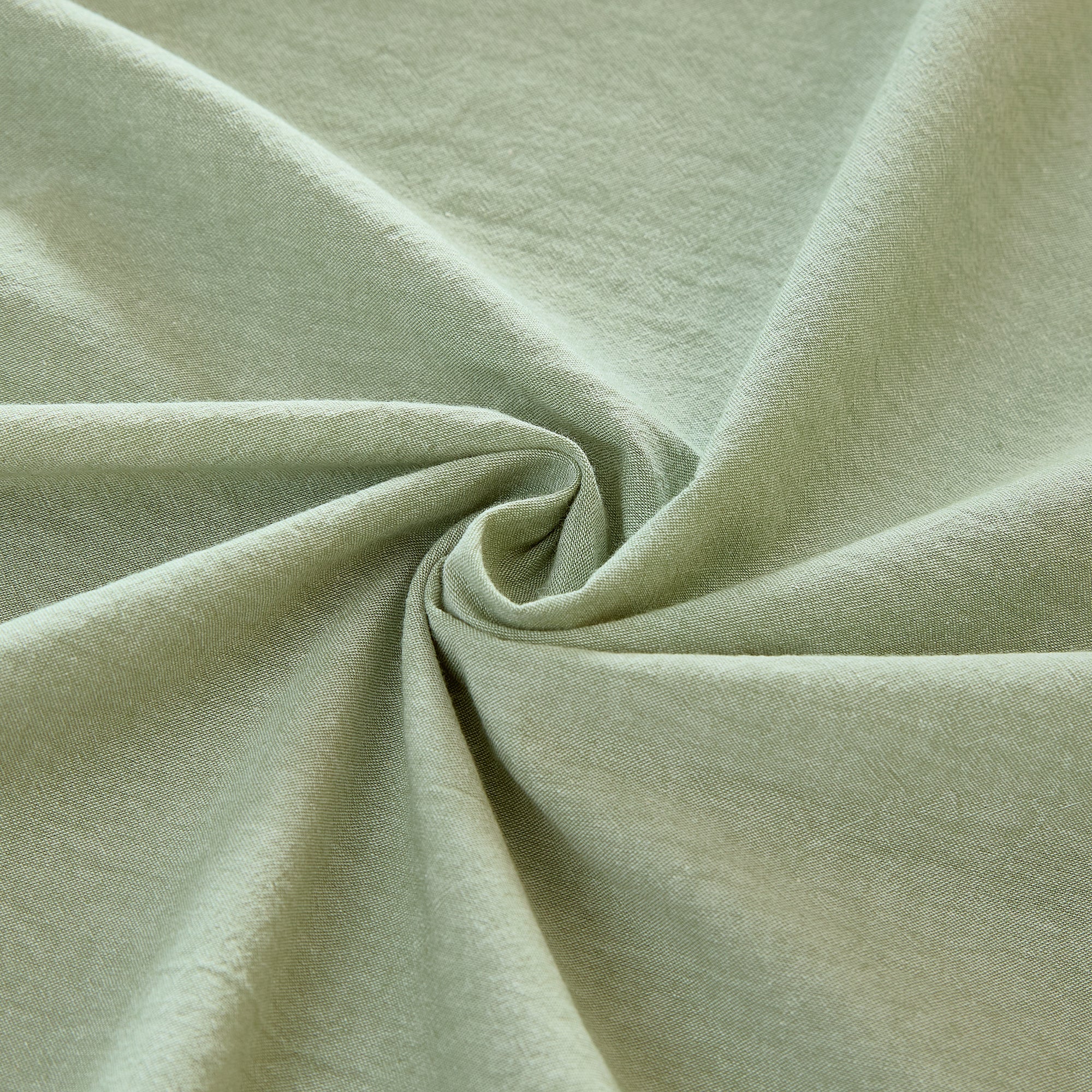 Close-up of light green fabric with folds