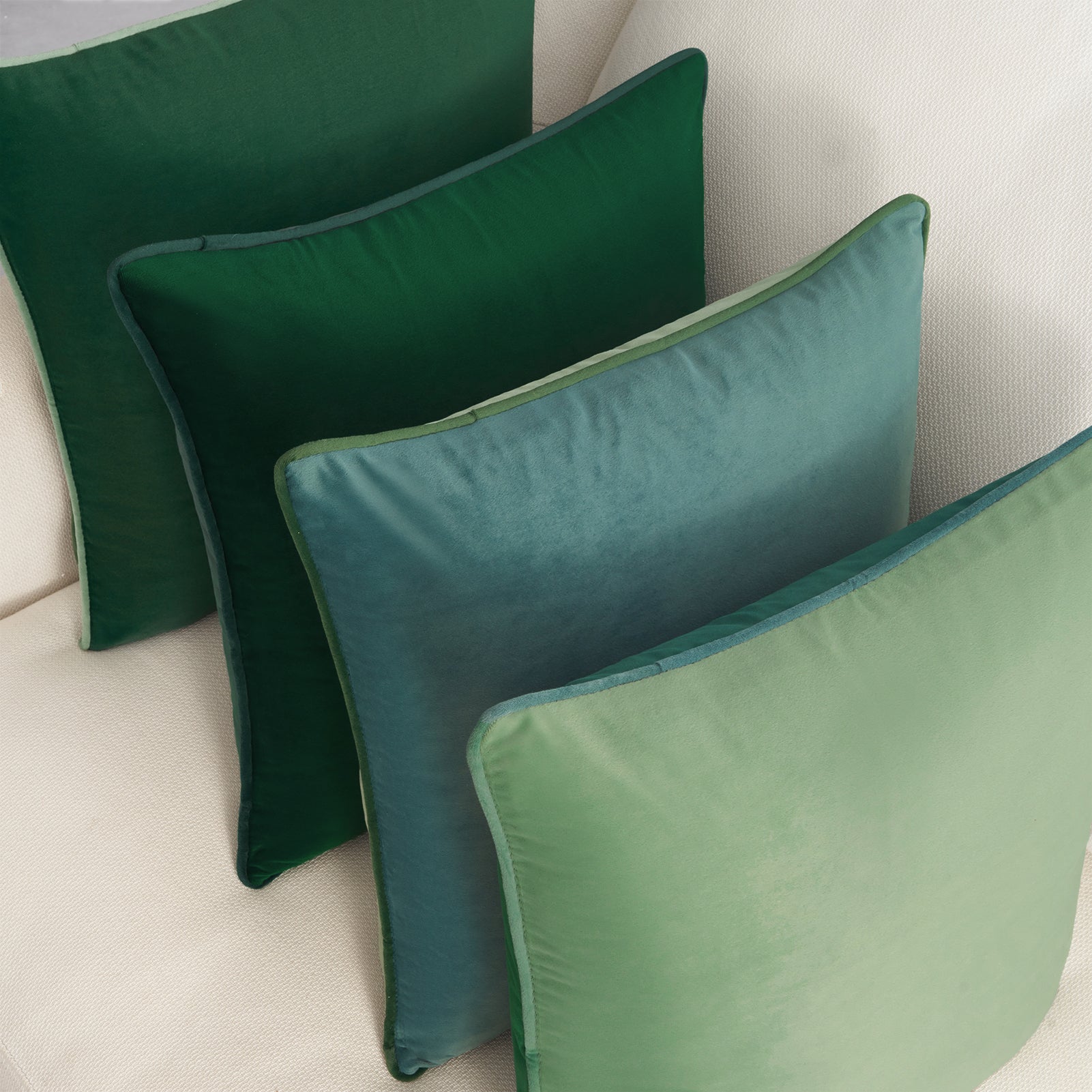 Set of green pillows on a beige sofa