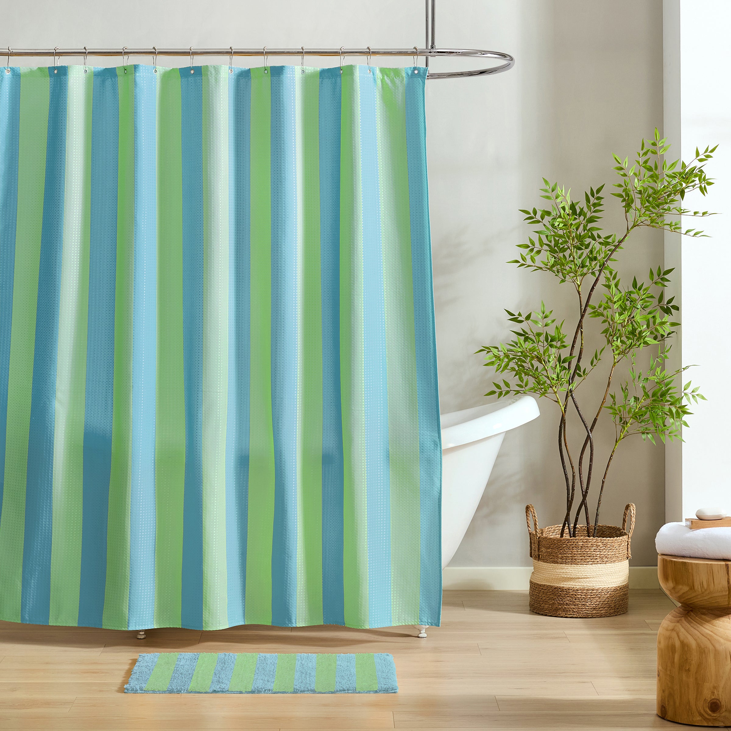 Striped shower curtain with matching rug in a bathroom setting