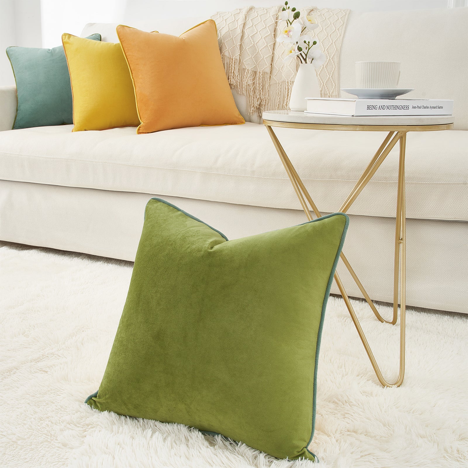 Green pillow on a white rug with a couch and side table in the background