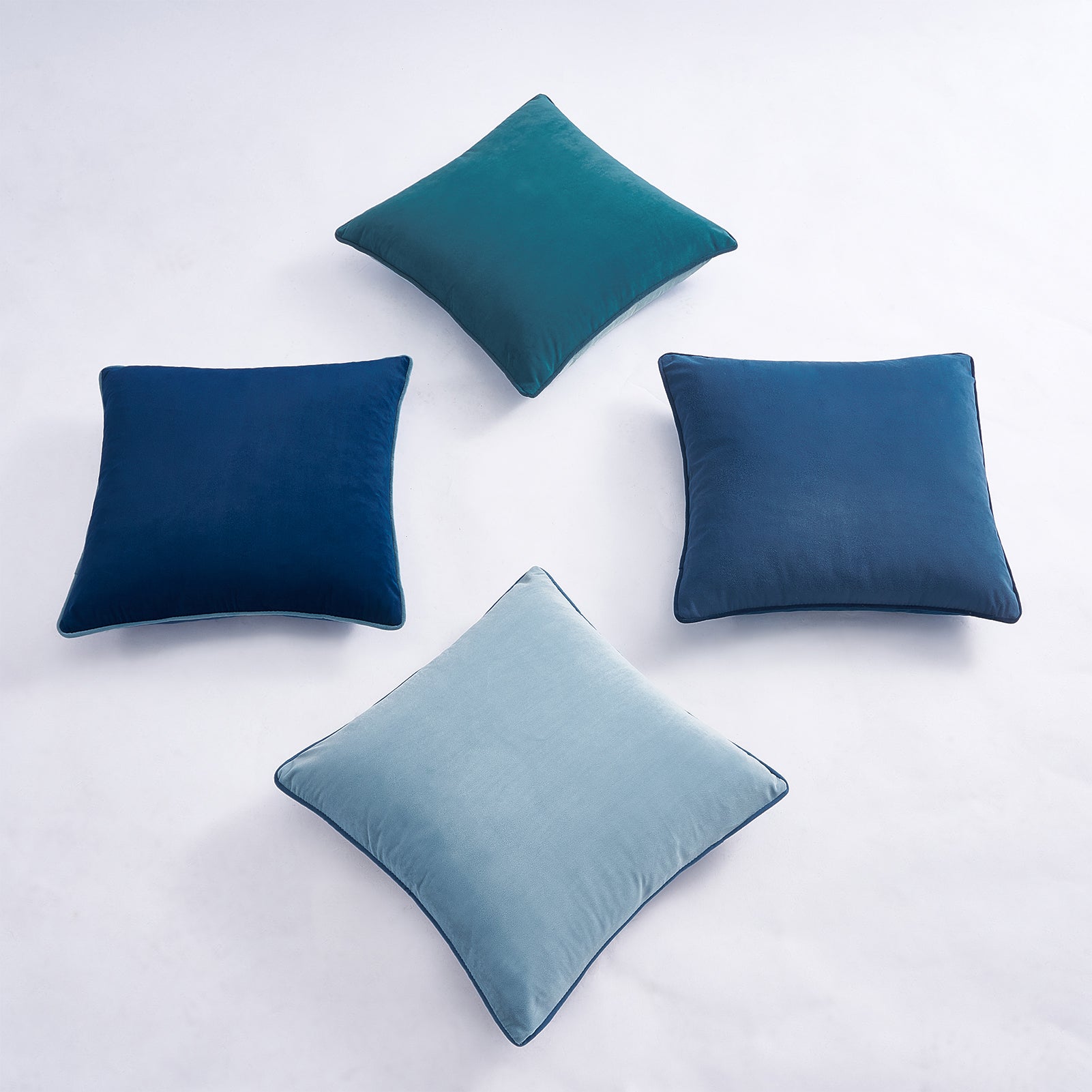 Four blue pillows on a white background
