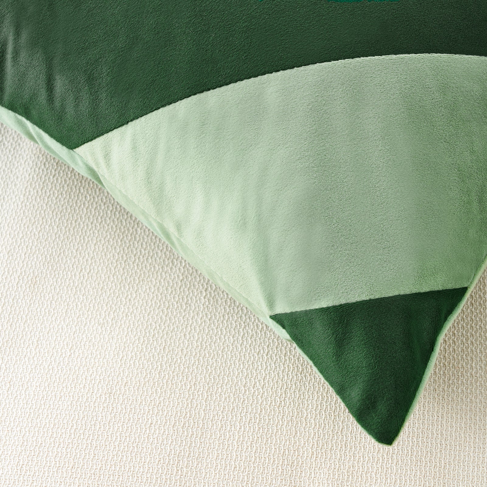 Green and white bedding set on a neutral background