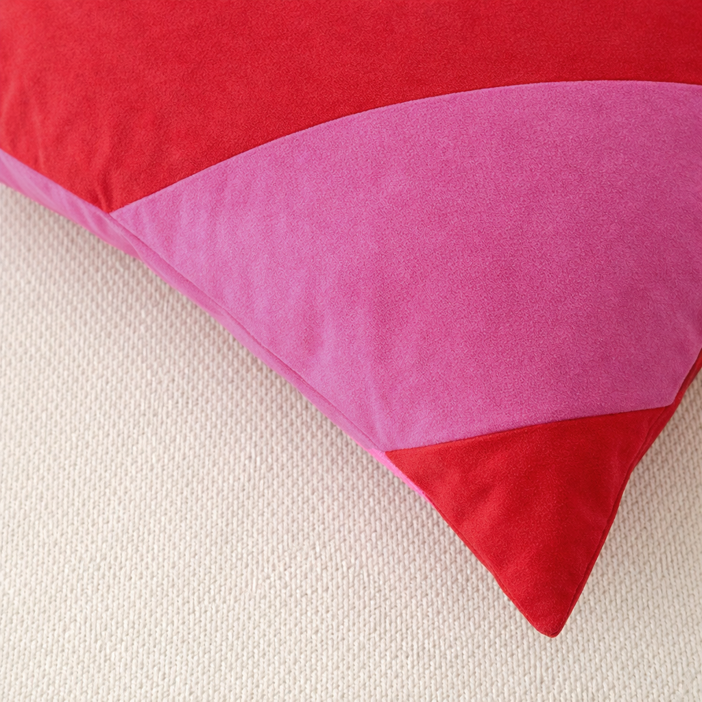 Close-up of a red and pink pillow on a beige surface