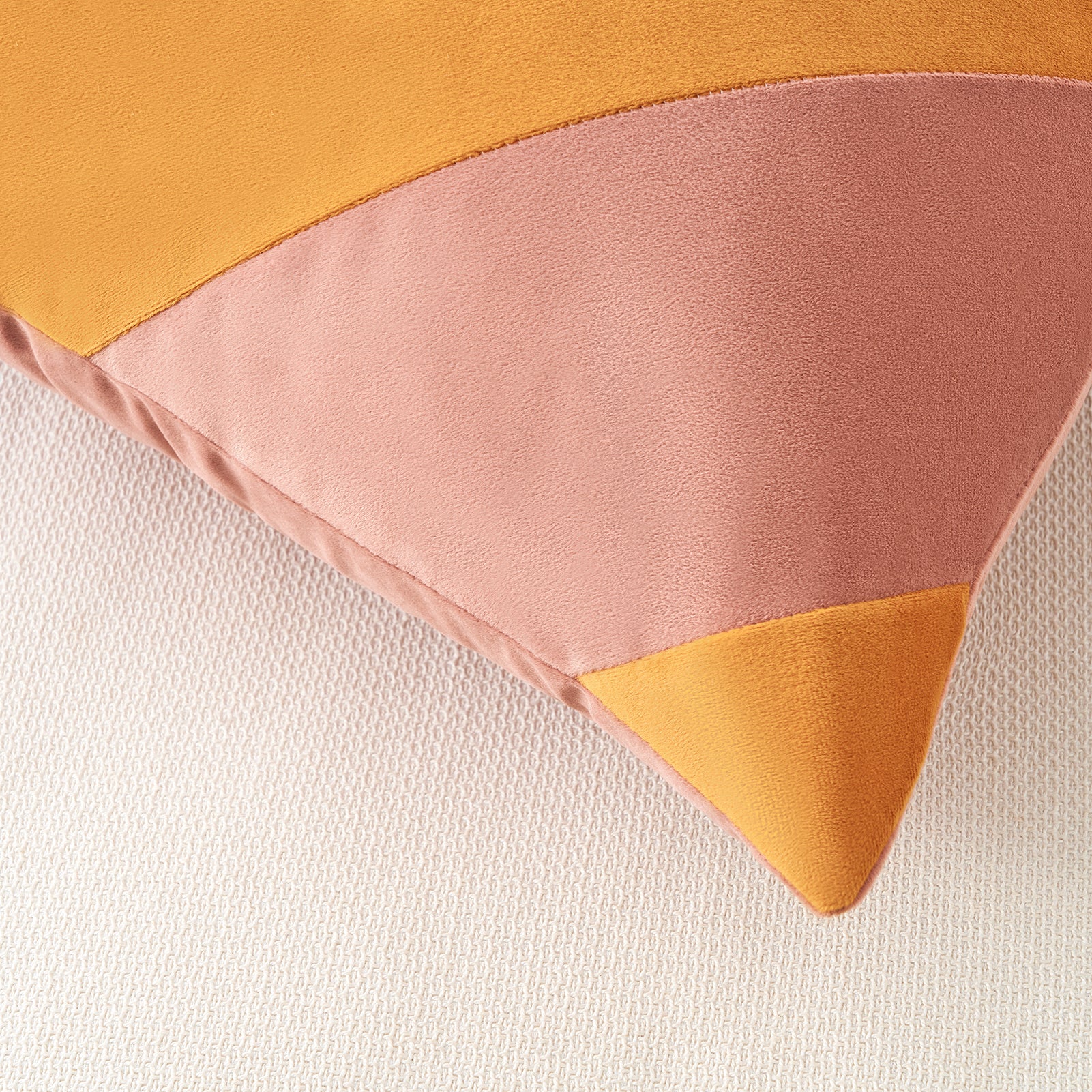 Color-blocked fabric with pink and orange triangles on a white background
