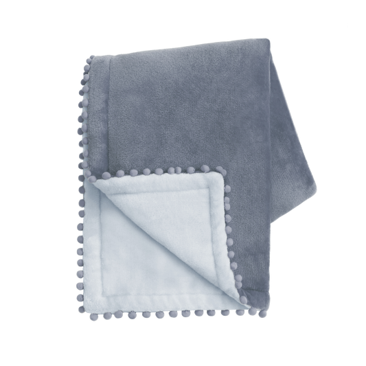 Gray blanket with pom-pom trim on a white background